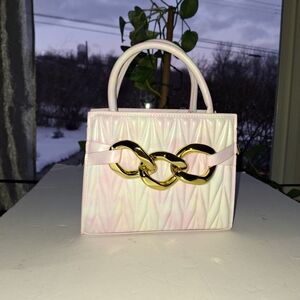 Stylish Pink and Gold Mini Bag with Textured Surface and Bold Hardware